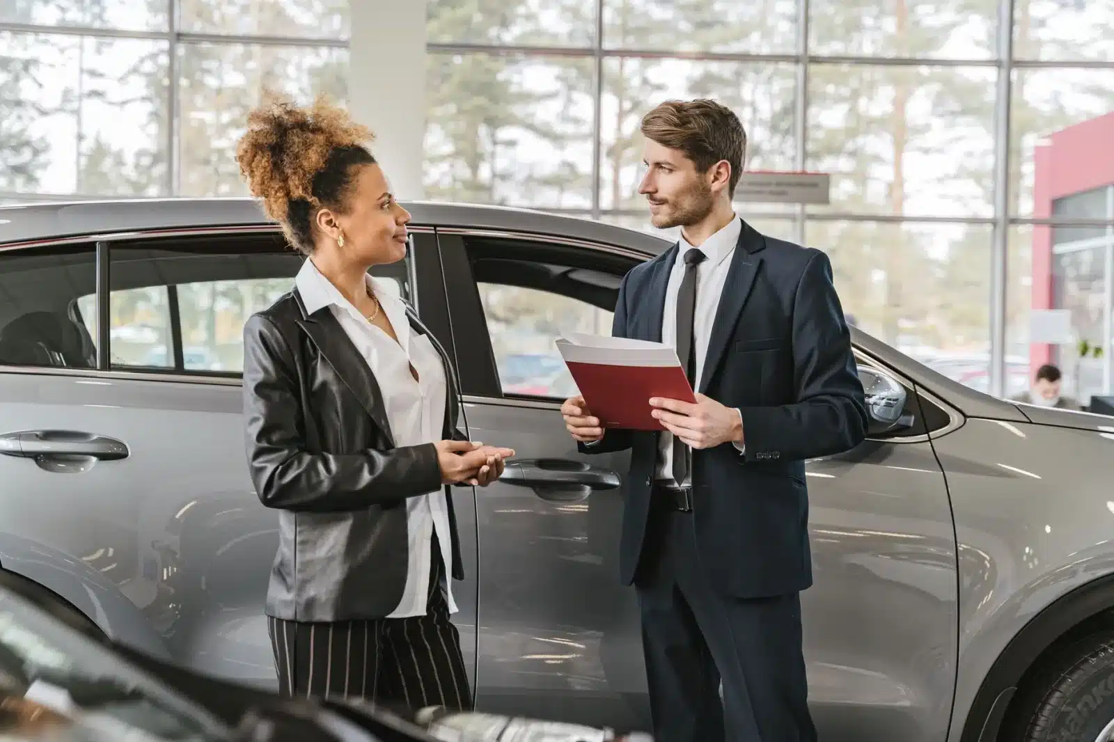 Client français signant un contrat d'achat chez un concessionnaire automobile allemand