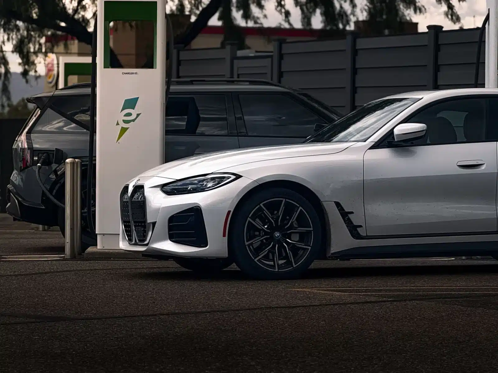 Couple rechargeant une voiture électrique éligible au leasing social