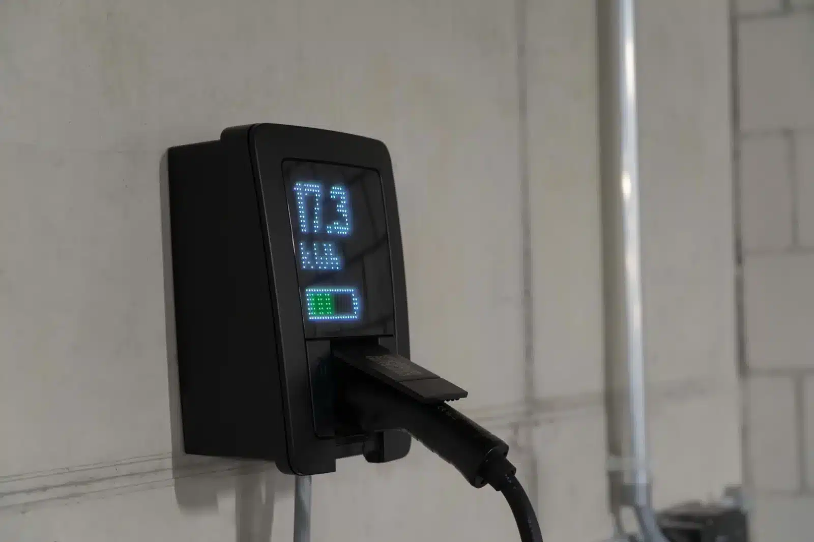 Écran de borne de recharge affichant la puissance de charge en kW et le pourcentage de batterie