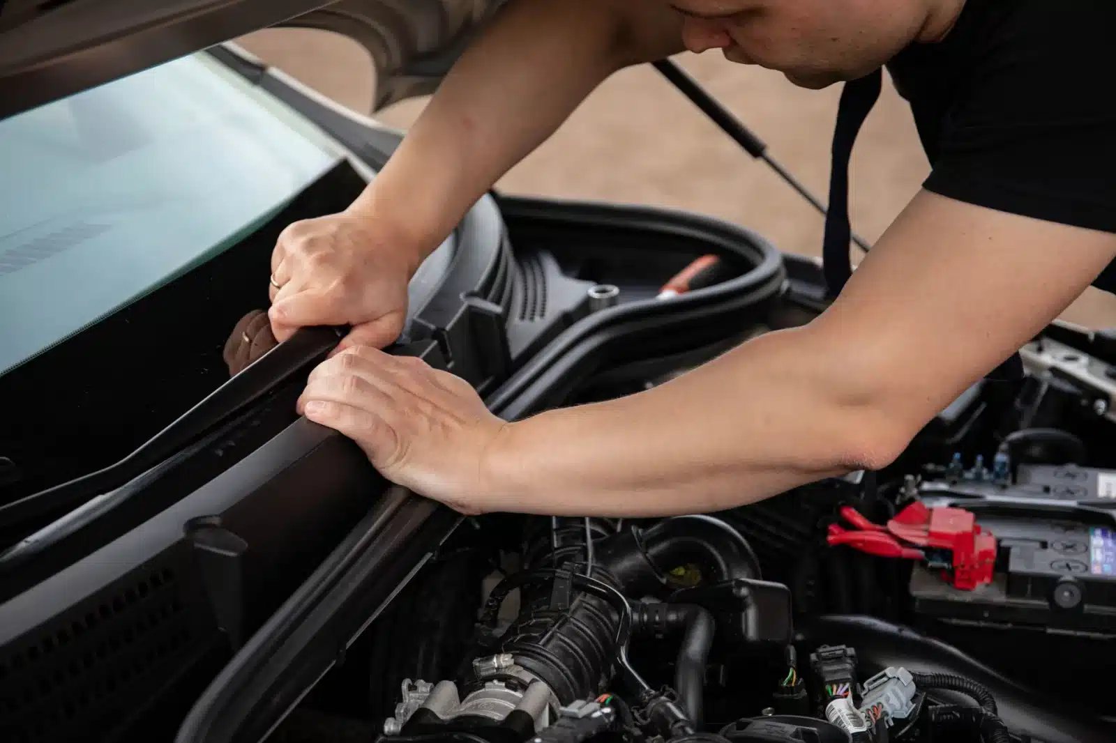 Inspection minutieuse des joints en caoutchouc fissurés d'une fenêtre de camping-car avec une lampe torche