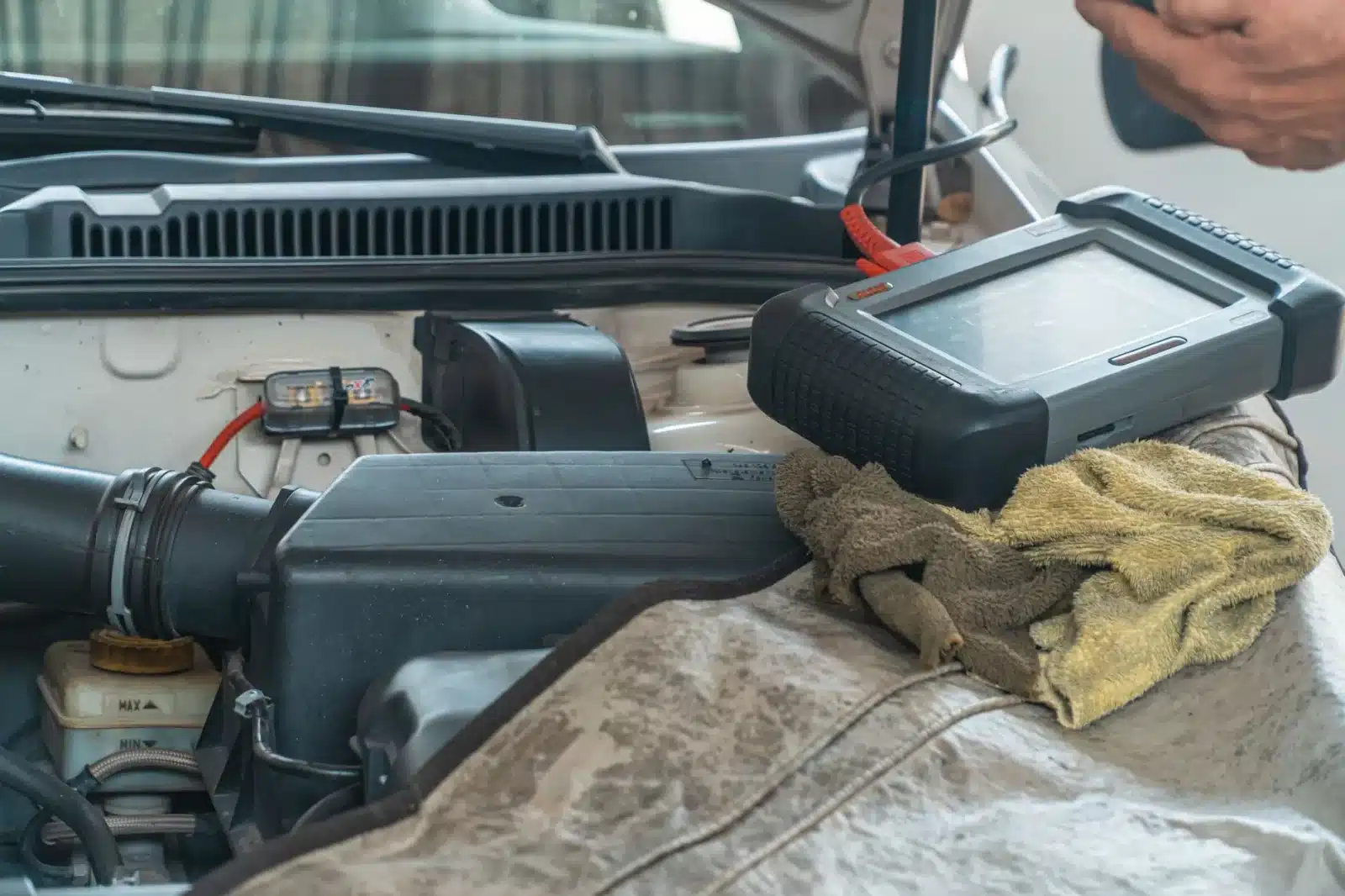 Mécanicien vérifiant une courroie de distribution sur un moteur essence