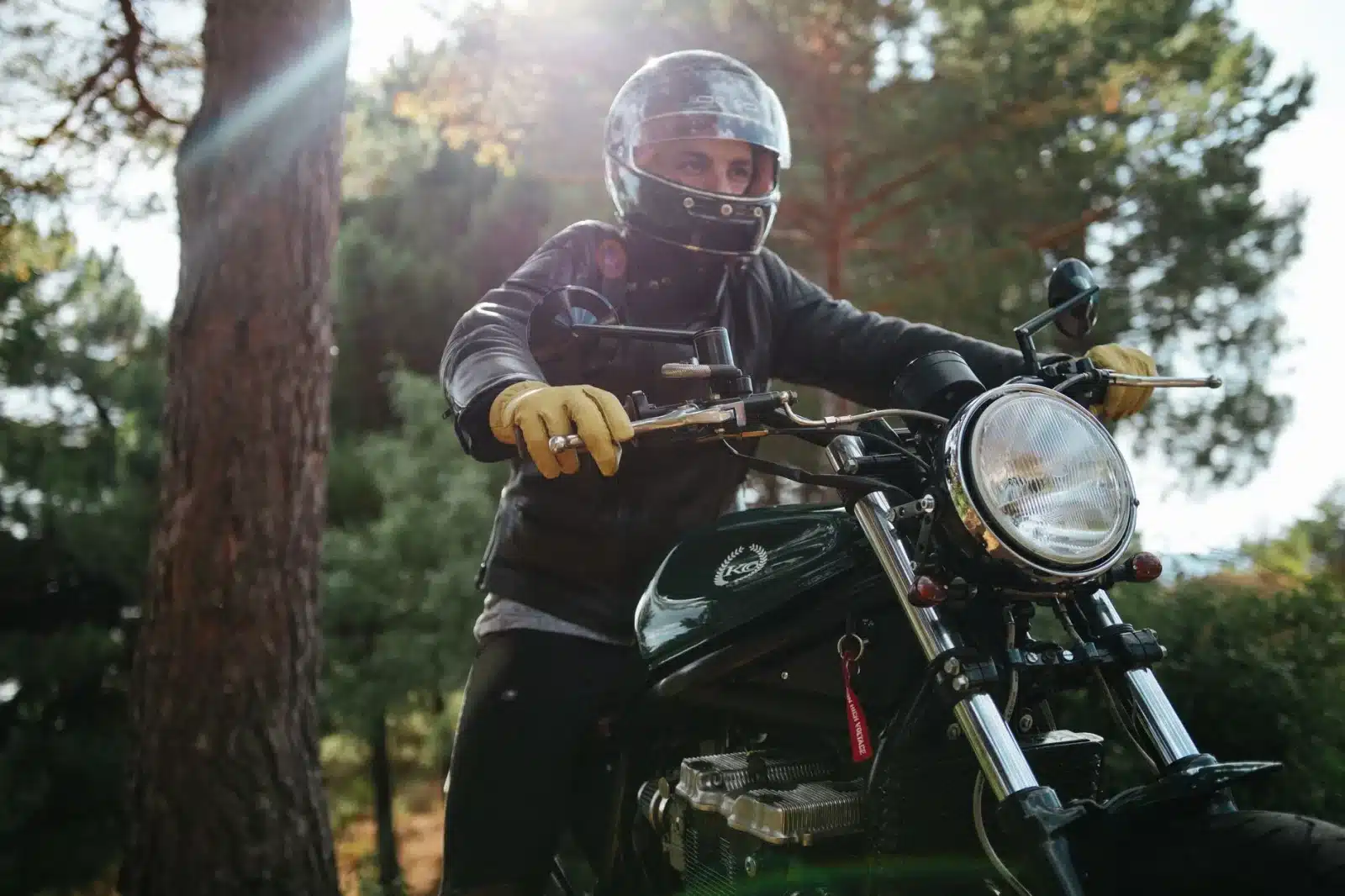 Motard équipé de gants homologués et d'un casque sur une route